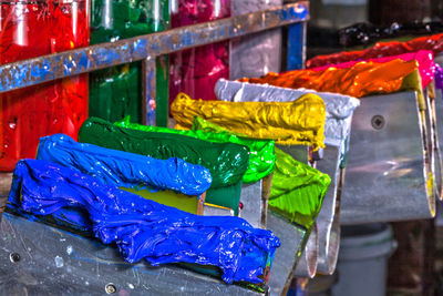 Close-up of colorful paints in containers for sale