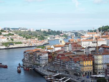 High angle view of cityscape by sea against sky