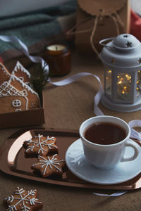 Aesthetics christmas mood with gingerbread cookies, cocoa, light, candles background.