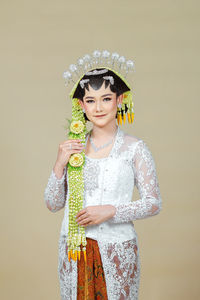 Beautiful model, wearing javanese indonesian wedding dress.