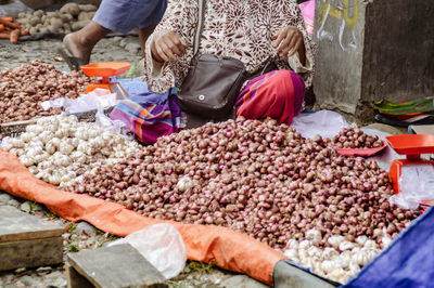 A street market vendor selling her home grown garlic and onions in medan, indonesia