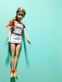 Low angle view of smiling young woman standing against wall