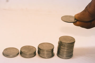 Close-up of hand holding coins