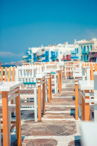 Row of buildings in city against blue sky