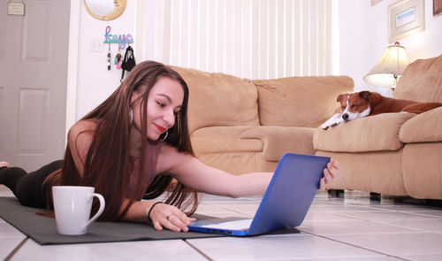 Young woman using laptop at home