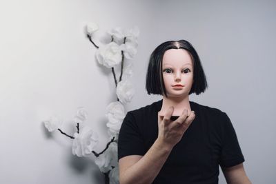 Portrait of a young woman against white background