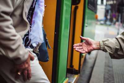 Conceptual close-up of hands of two people in the city