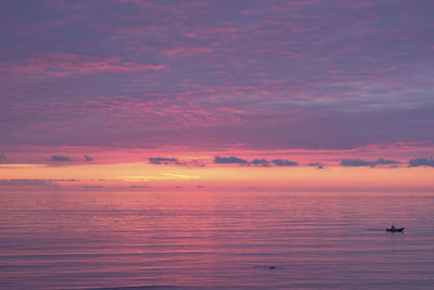 Scenic view of sea against orange sky