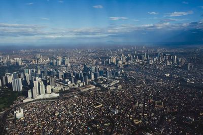 High angle view of city against cloudy sky