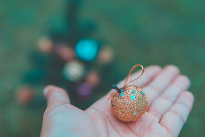 Close-up of hand holding christmas decoration