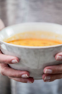 Close-up of hand holding bowl