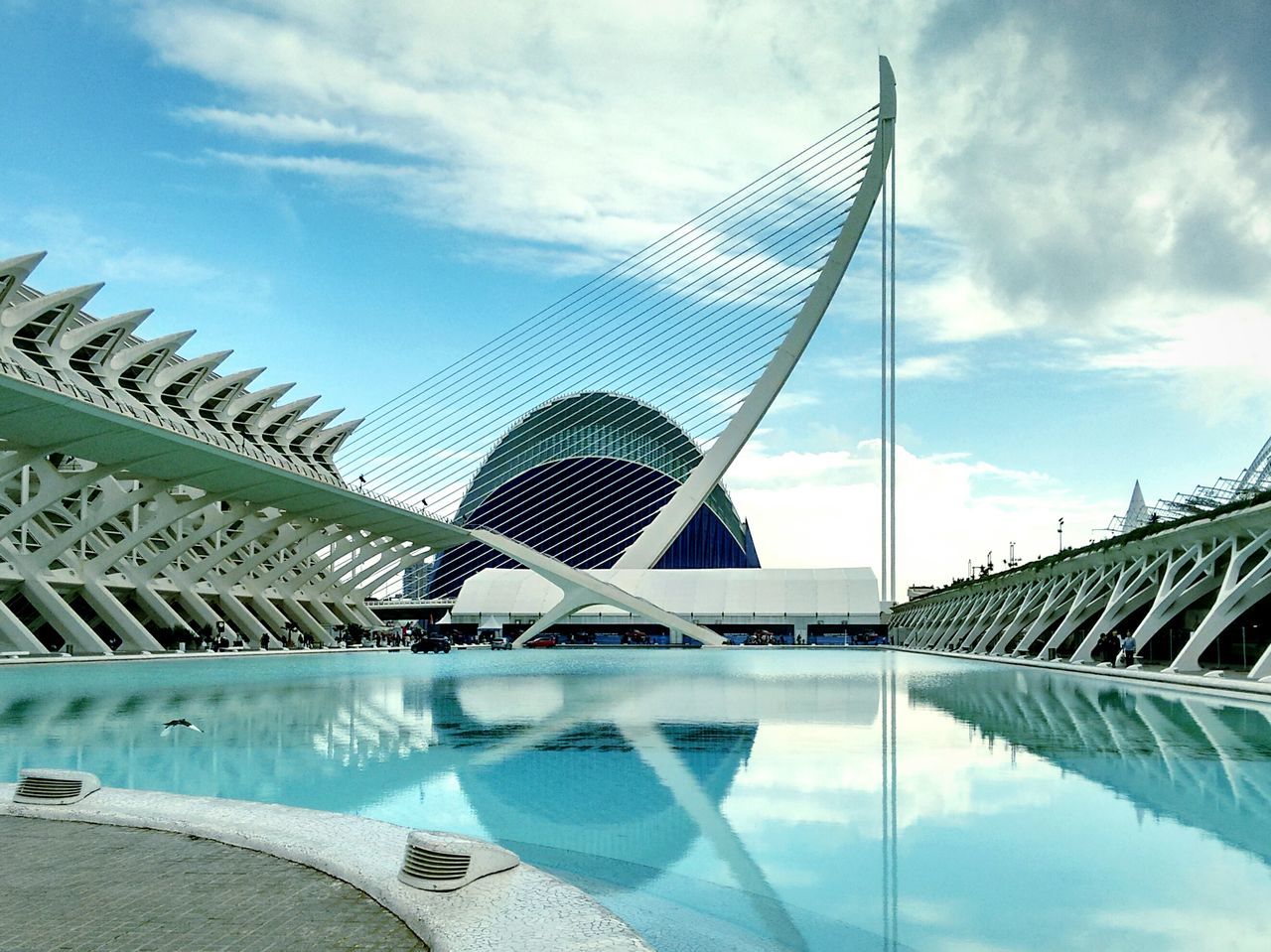 built structure, architecture, low angle view, sky, building exterior, cloud - sky, modern, blue, famous place, tall - high, city, reflection, cloud, international landmark, day, travel destinations, tower, capital cities, outdoors, travel