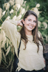Portrait of a smiling young woman standing outdoors