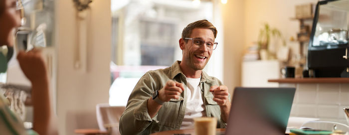 Side view of man using mobile phone in office