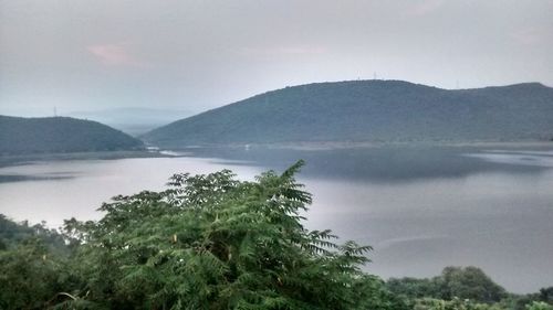 Scenic view of lake and mountains against sky