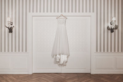 Clothes hanging on white wall