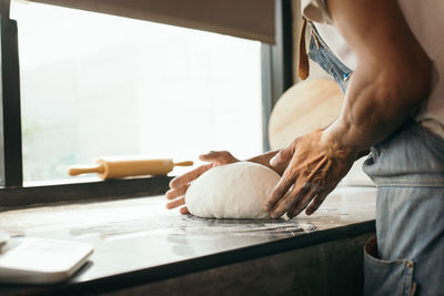 Midsection of man preparing food