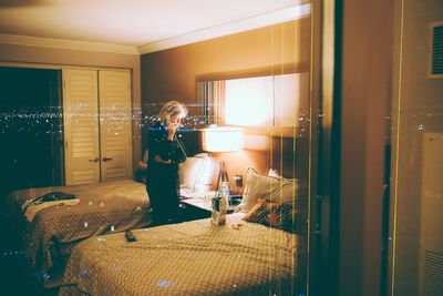 Woman standing by window