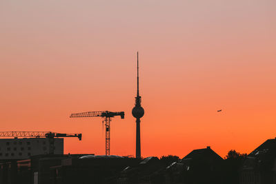 Fernsehturm in city during sunset