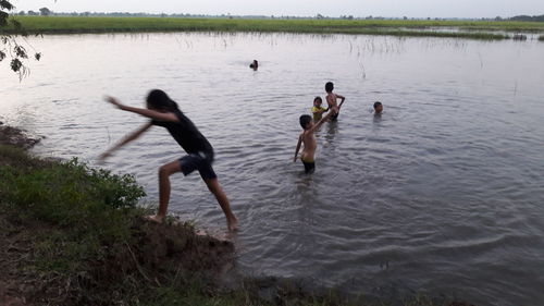 People swimming in lake