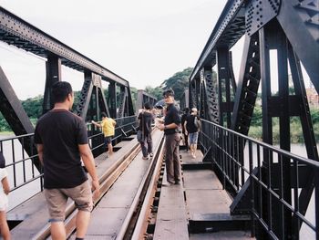 People walking on footbridge