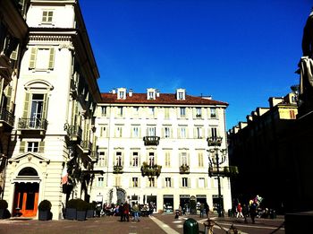 Buildings in city against blue sky