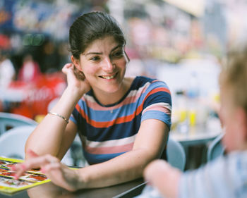 Portrait of a smiling girl sitting on table