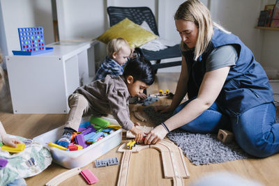 Teacher with children in playschool