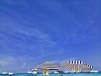 Built structure on beach against blue sky