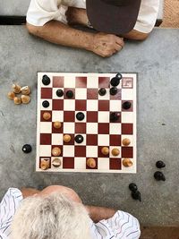 High angle view of man playing chess on table