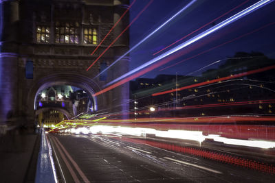 Light trails on bridge in city at night