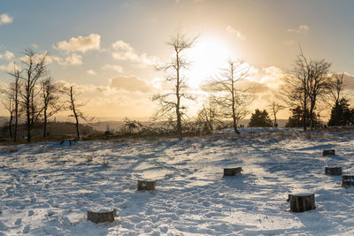 Scenic view of snow covered field against sky