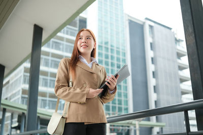 Portrait of young woman using mobile phone