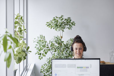 Woman wearing headset working in office