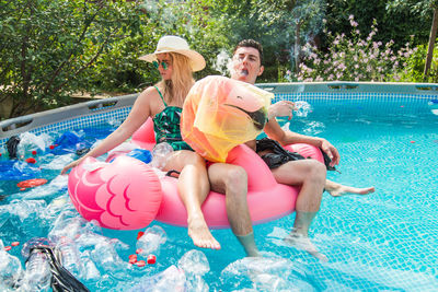 People sitting in swimming pool