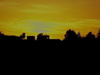 Silhouette trees against sky during sunset