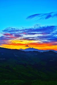 Scenic view of silhouette landscape against sky at sunset