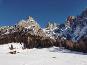 Scenic view of snowcapped mountains against clear blue sky