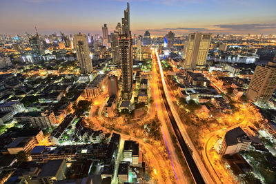 High angle view of illuminated street amidst buildings in city