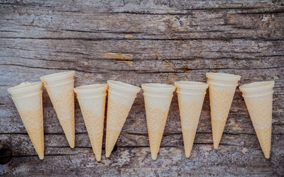 High angle view of ice cream cones on wooden table