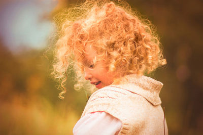 Close-up of girl blowing spider web