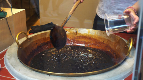 Close-up of person preparing food in kitchen