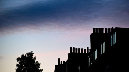 Low angle view of building against cloudy sky