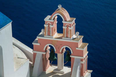 High angle view of building by sea against blue sky