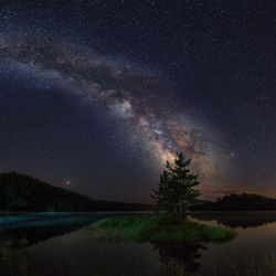 Scenic view of lake against star field at night