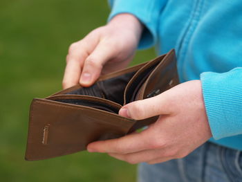 Cropped image of man holding empty wallet