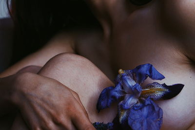Close-up of woman with pink flower