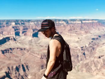 Side view of man standing on rock