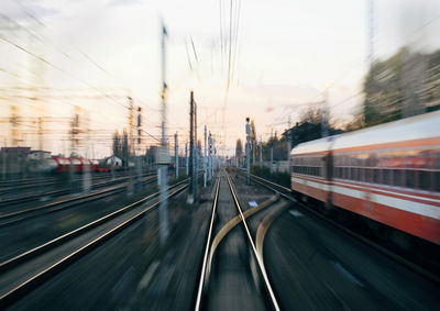 Blurred motion of train in city against sky