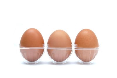 Close-up of eggs against white background